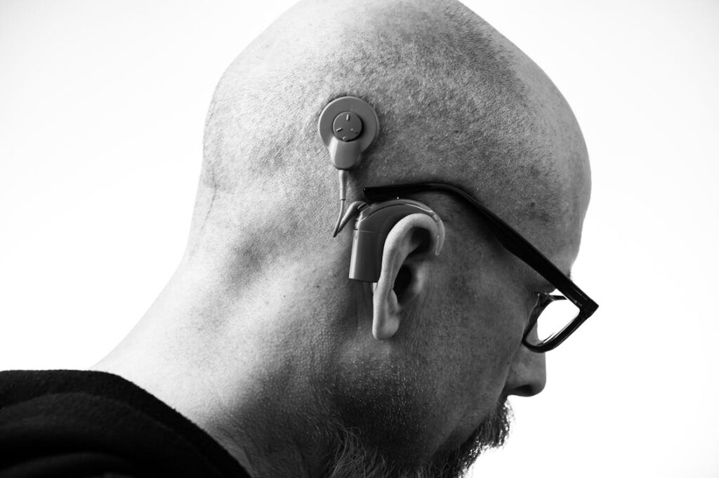 An individual using hearing aids for the elderly